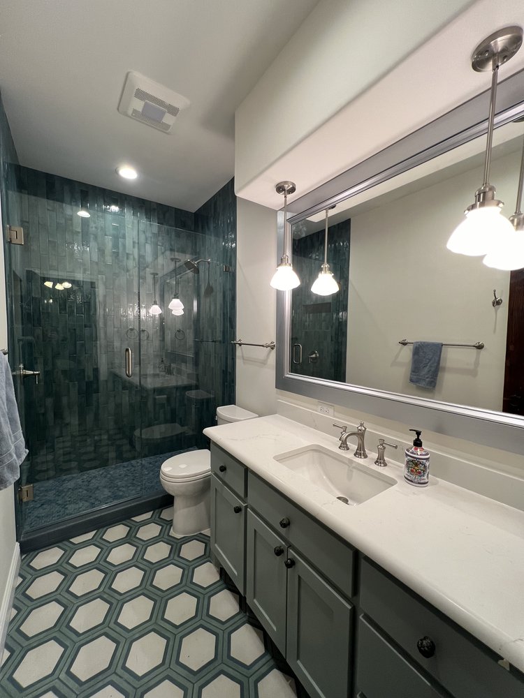 Full bathroom remodel with walk in shower, frameless glass, new tile, level 5 drywall and updated light fixtures.