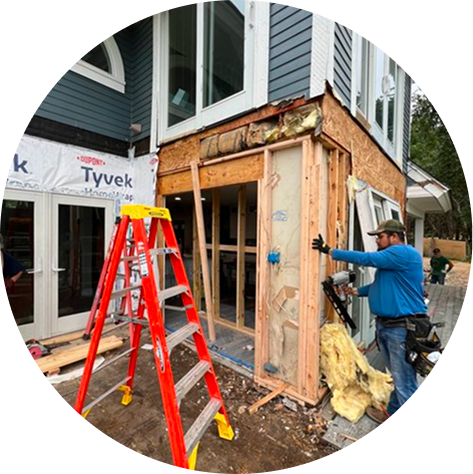 Workers repairing the exterior of a home in Wimberly, Texas.