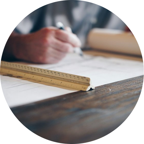 Interior designer at a drafting table working on home designs.