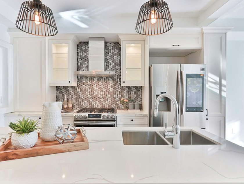 Large apartment kitchen with high ceilings. Custom kitchen island with large bar and stools