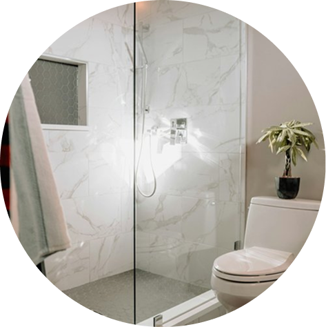 Walk in shower with frameless glass and a shower niche.