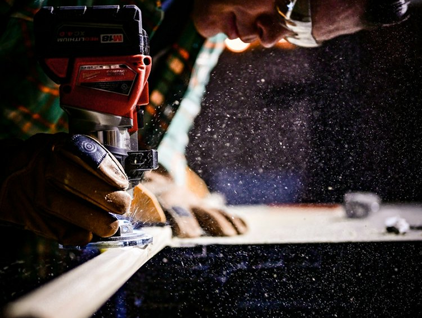 A Round Rock, Texas carpenter using a router on a piece of trim for a kitchen Remodel.