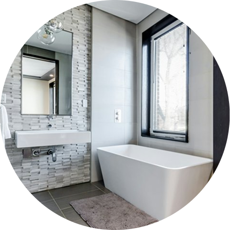 Free standing tub and floating vanity in a newly remodeled bathroom.