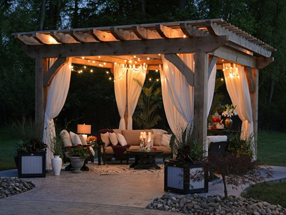 An elegant pergola surrounding a backyard dining set.