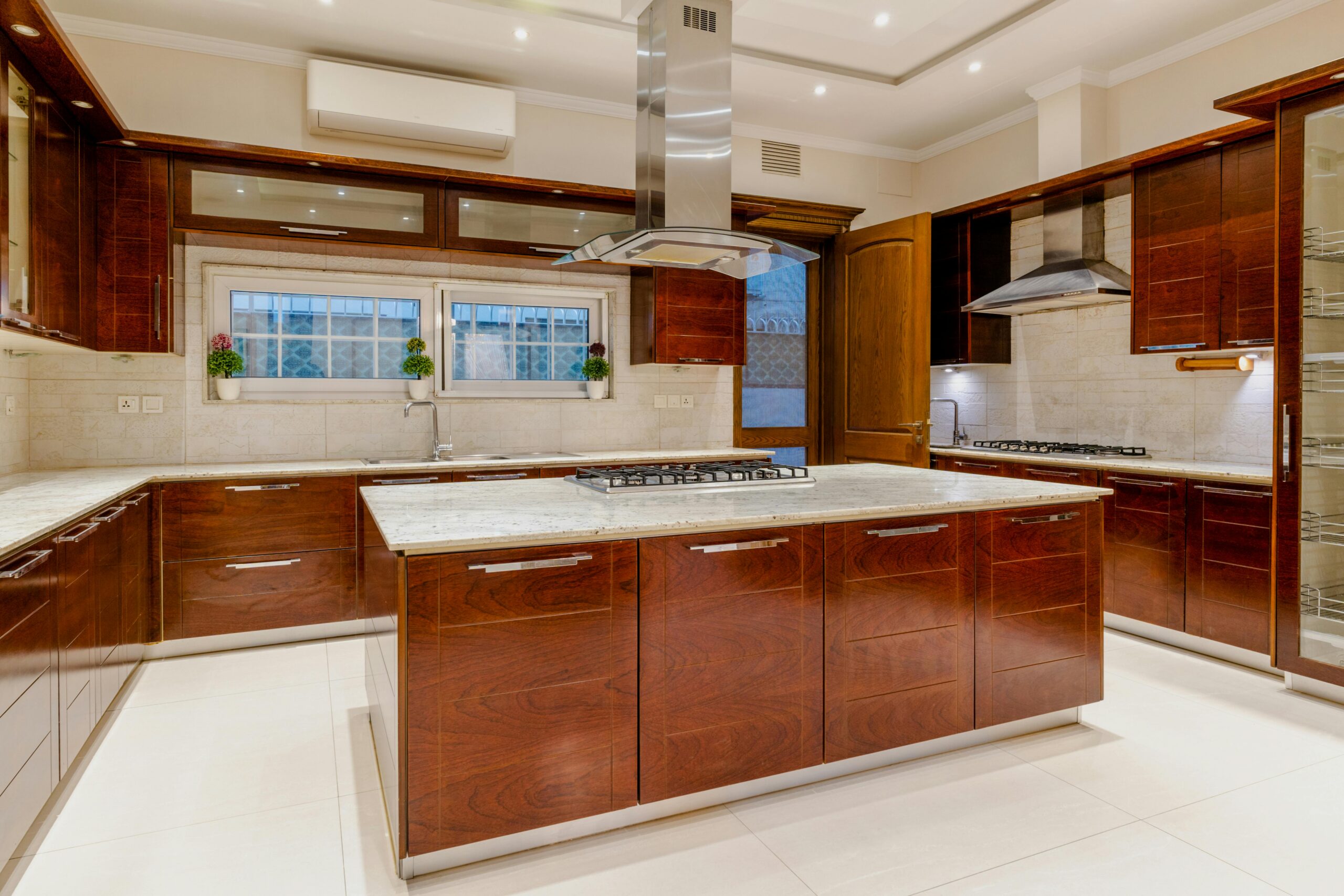 Modern kitchen with wood cabinetry and a large island, illustrating a finished Austin kitchen remodel