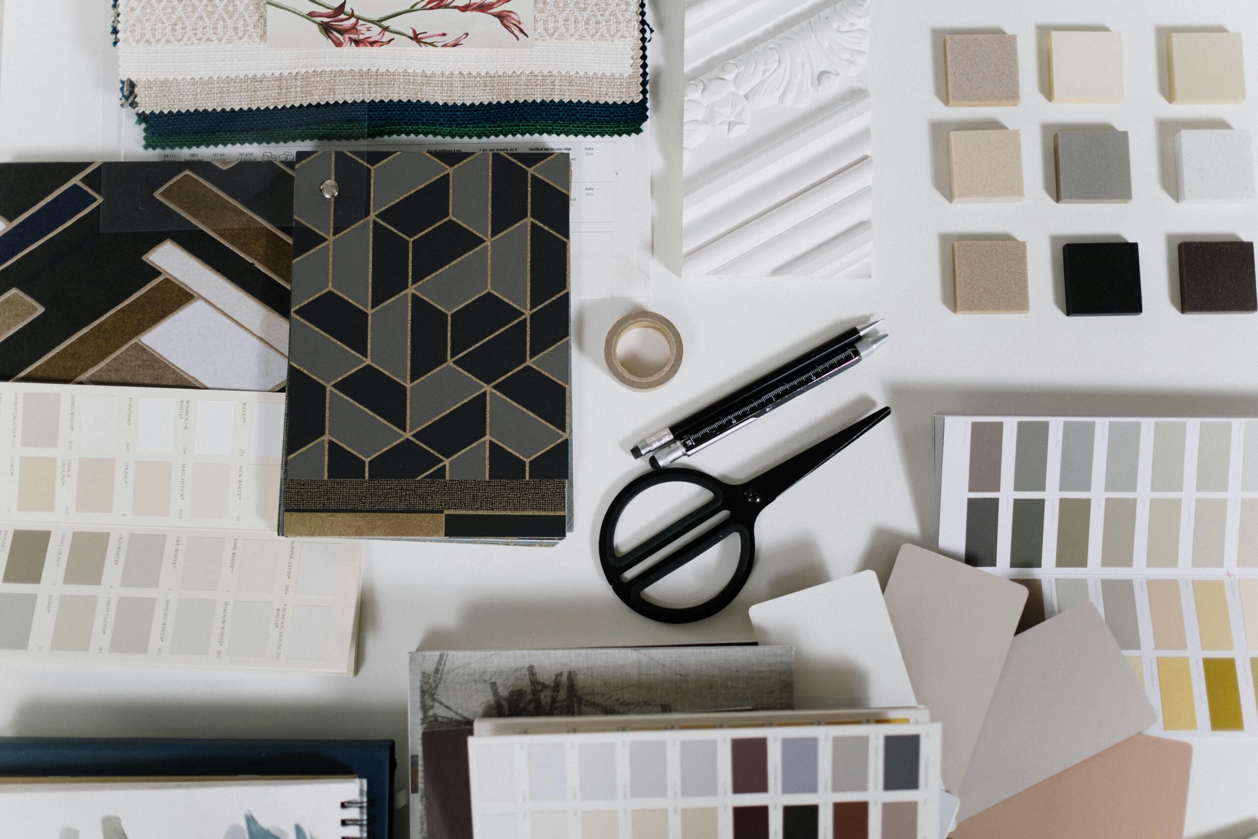 Interior design material samples and finish selections laid out on a table during remodel planning