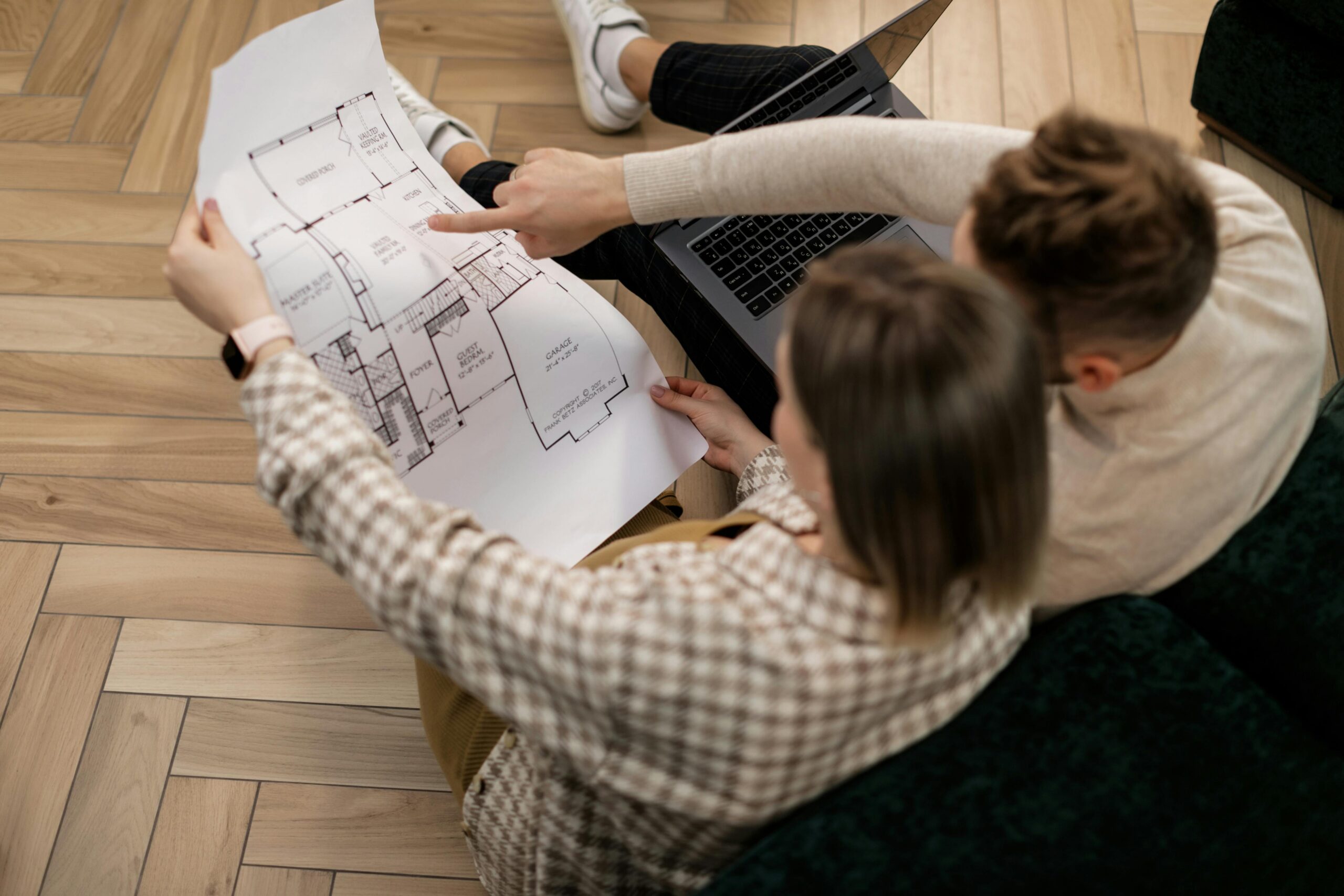 Homeowners reviewing blueprints together before starting a home remodeling project
