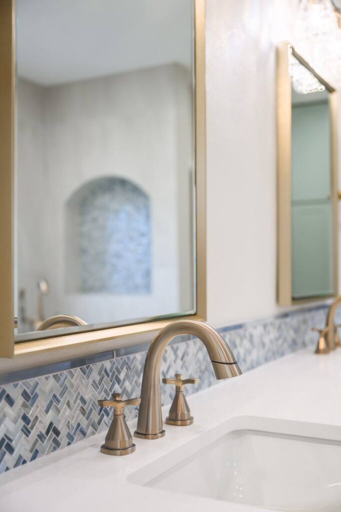 Spanish Oak vanity close-up with brass faucet and blue mosaic backsplash