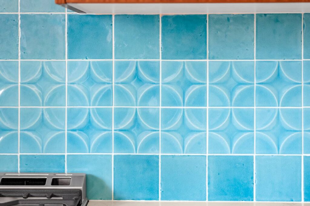 E 18th Street turquoise backsplash close-up with sculpted pattern and glossy finish