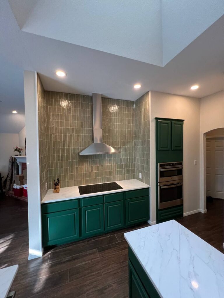 Dapplegrey kitchen range wall with green cabinetry, sage tile backsplash, quartz counters