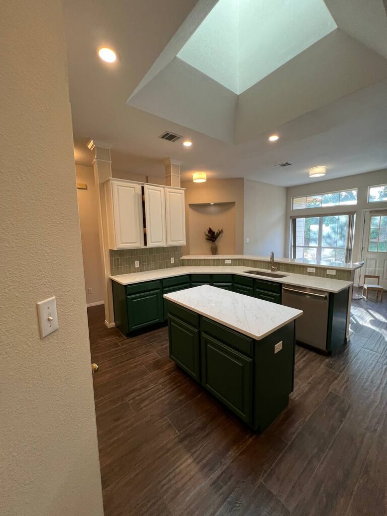 Dapplegrey kitchen range wall with sage tile backsplash, stainless hood, green base cabinets