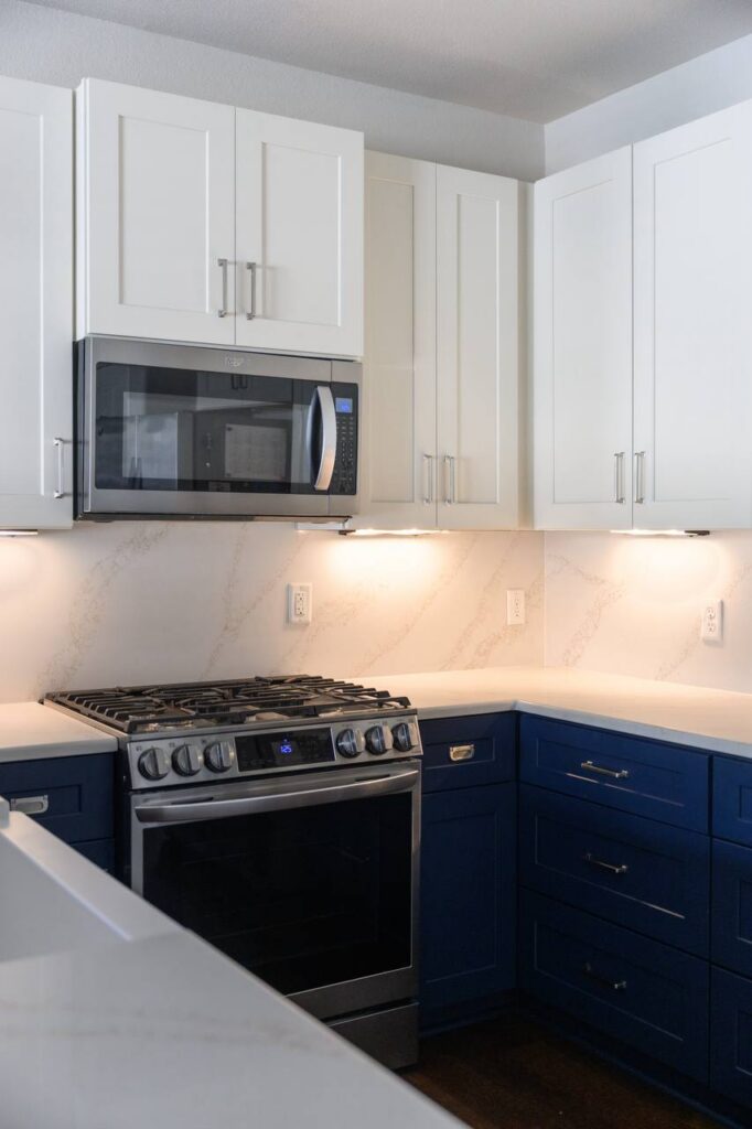 S Lakeline Blvd. vanity with light wood fluted cabinets, white countertop, brass hardware