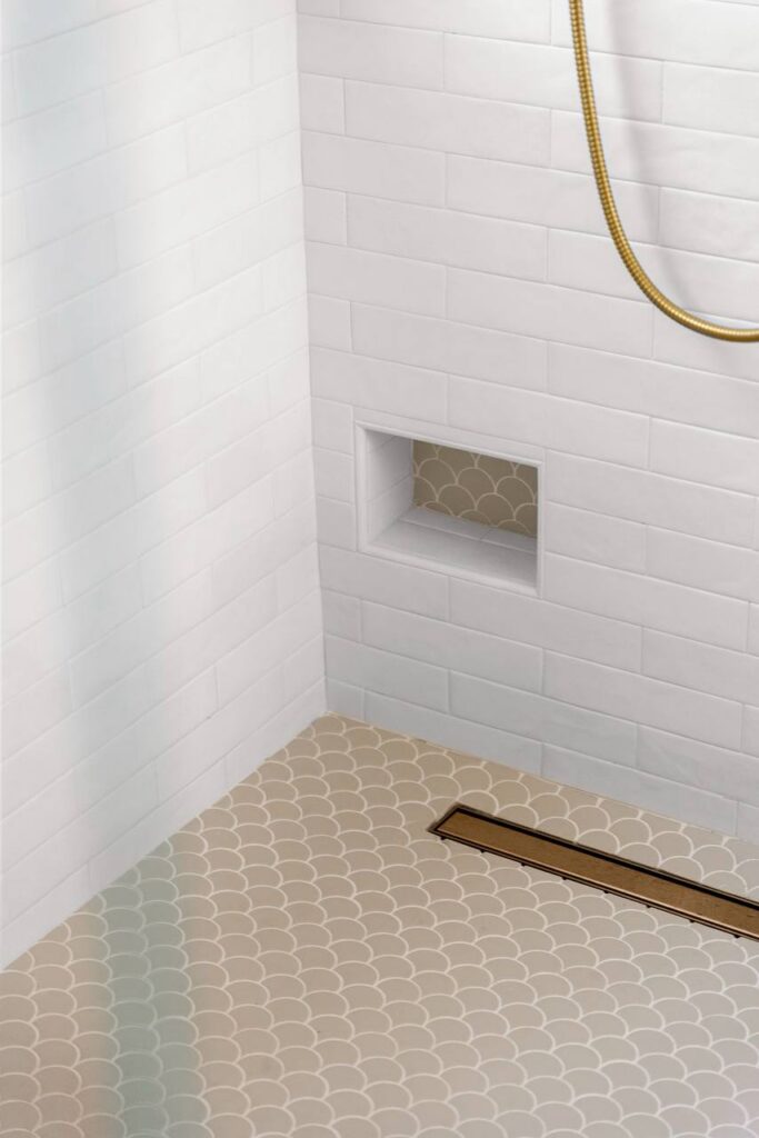 Lomita Verde shower shelving with scallop tile accent and white niche